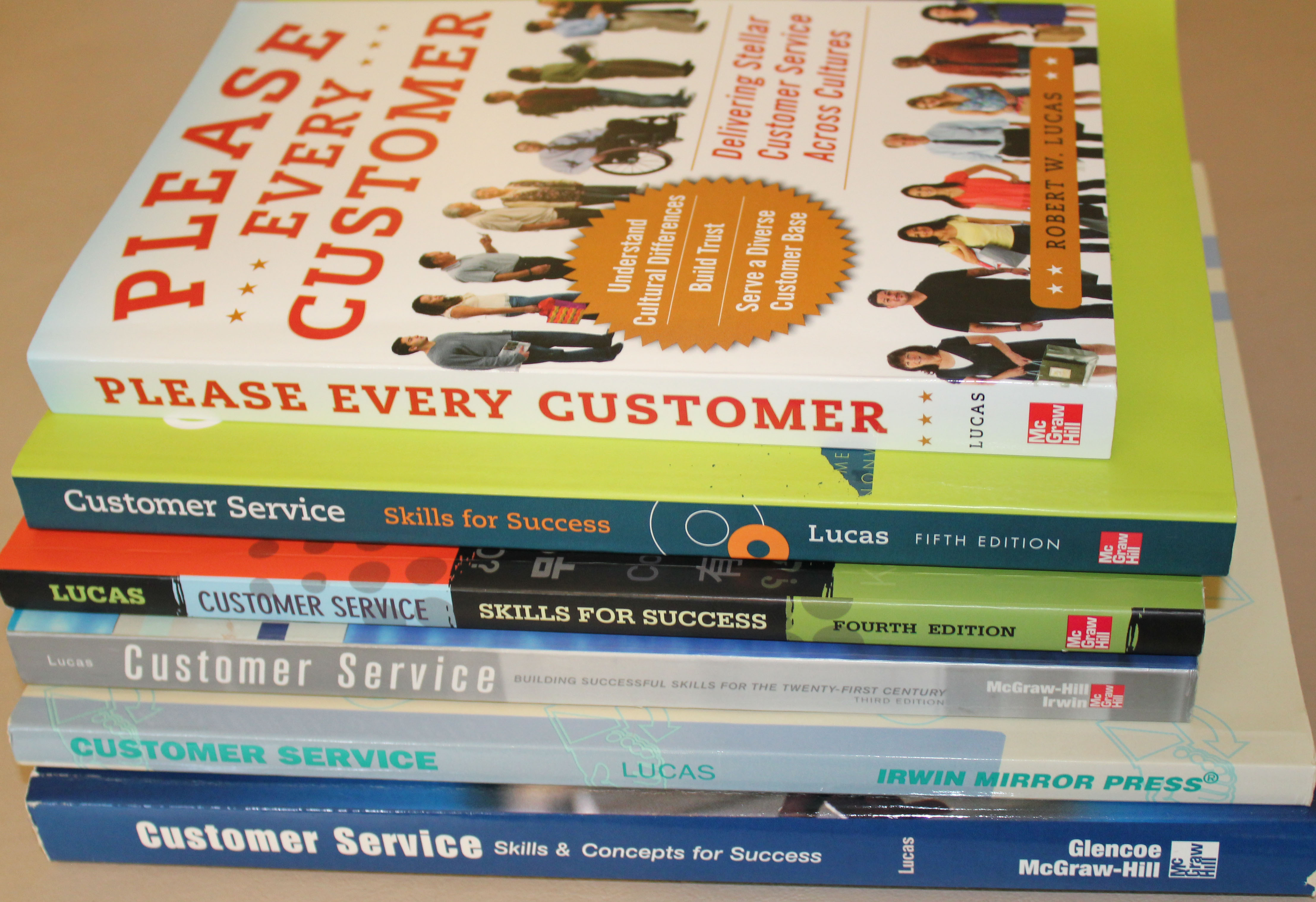Bob's customer service books stacked Nonfiction Author and Writer